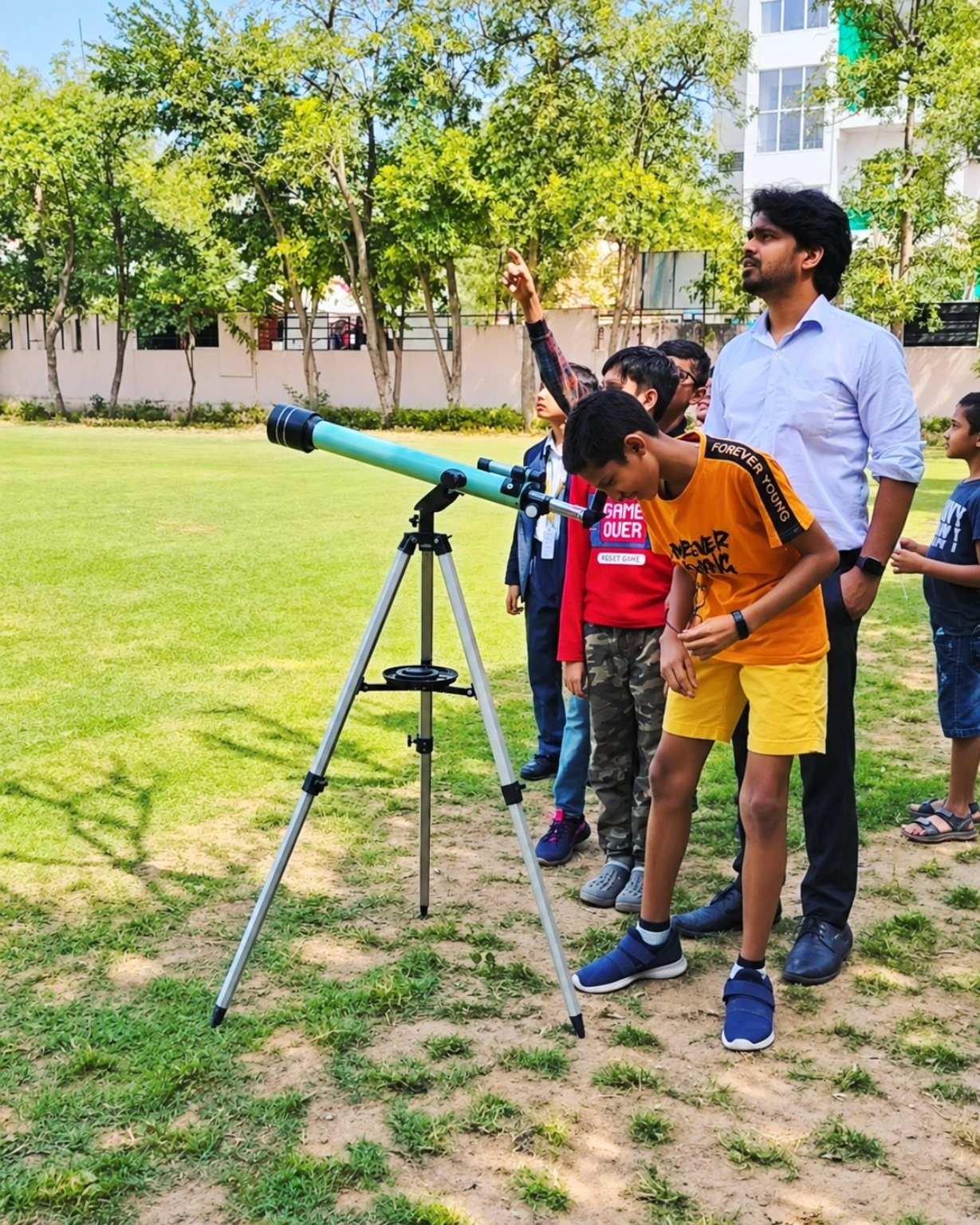 Students exploring a telescope